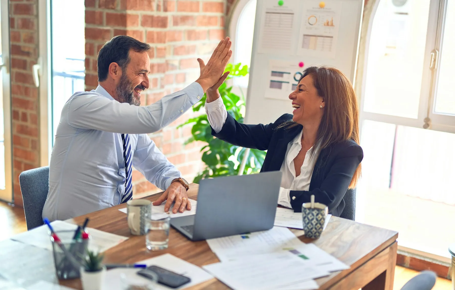 Team of 1 Solutions professionals working together in an office